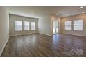 Spacious living room with hardwood floors, recessed lighting, and sliding glass doors to the backyard at 1600 Baymont Ct, Stanley, NC 28164