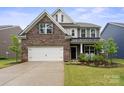 Charming two-story home with brick and siding, a well-kept lawn, and a two-car garage at 17812 New Mark Ave, Charlotte, NC 28278