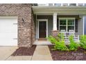 Inviting front porch with rocking chairs, stylish siding, and brick accents at 17812 New Mark Ave, Charlotte, NC 28278