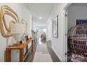 Elegant hallway featuring hardwood floors, neutral walls, and stylish decor at 17812 New Mark Ave, Charlotte, NC 28278