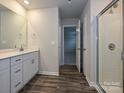 Bathroom featuring a glass door shower, wood floor, and vanity with a white countertop at 2139 Rolling Hills Ct, Stanley, NC 28164