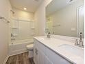 Bathroom showcasing double sinks with white countertops and a shower-tub combo at 2139 Rolling Hills Ct, Stanley, NC 28164