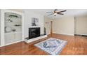 Cozy living room featuring a fireplace, hardwood floors, and built-in shelving for a welcoming atmosphere at 220 Pinehurst Ln, Newton, NC 28658