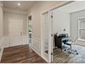 Bright foyer with hardwood flooring leading to a study with glass French doors and trim work at 2329 Delaney Dr, Fort Mill, SC 29715