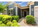 Inviting home entry featuring a well-landscaped walkway with lush plantings and a modern entry door at 2329 Delaney Dr, Fort Mill, SC 29715