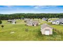 Expansive backyard with outbuilding and patio, surrounded by a scenic neighborhood with lush trees at 3645 Kimber Ln, Sherrills Ford, NC 28673