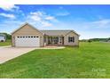 Inviting exterior showcasing a well-manicured lawn and a charming front porch, perfect for relaxing evenings at 3645 Kimber Ln, Sherrills Ford, NC 28673