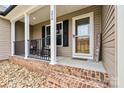 Inviting front porch with rocking chairs, stylish door, and attractive brick and stone accents at 3645 Kimber Ln, Sherrills Ford, NC 28673