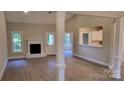 Bright living room featuring hardwood floors, a fireplace, and an open floor plan at 3712 Travertine Dr, Lancaster, SC 29720