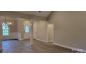 Living room with a view to front door, neutral walls, and hardwood floors at 3712 Travertine Dr, Lancaster, SC 29720
