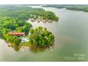 Aerial view of waterfront property at 3911 Sandy Point Rd, showing lush trees, a private dock and peaceful setting at 3911 Sandy Point Dr, York, SC 29745