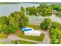 Aerial view of a lakeside home featuring mature trees, a private dock, and stunning waterfront views at 3911 Sandy Point Dr, York, SC 29745