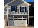 Exterior showcasing a one-car garage, gray siding, black shutters, and stone accents at 4041 Port Richmond Ave # 9, Gastonia, NC 28056