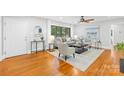 Bright living room featuring hardwood floors, neutral decor, and ample natural light at 4114 Stacy Blvd, Charlotte, NC 28209