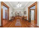 Long hallway with hardwood floors, decorative archway, and view of multiple rooms creates a grand entrance at 4569 Edgeland Rd, Edgemoor, SC 29712