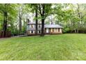 Inviting two-story home with brick and siding exterior, nestled among mature trees and a green lawn at 509 Selkirk Pl, Charlotte, NC 28270