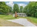 Inviting one-story home with a gravel driveway and well-manicured landscaping at 518 Westside Cir, China Grove, NC 28023