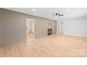 A bright living room with brick accent wall, fireplace, and new floors at 518 Westside Cir, China Grove, NC 28023