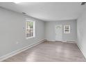 Spacious living room with neutral paint, new floors, and natural light at 6216 Bandy Dr, Charlotte, NC 28227