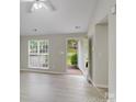 Open living area with new flooring, a large window, and a view of the front yard at 6216 Bandy Dr, Charlotte, NC 28227