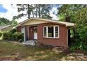 Lovely brick home with a manicured lawn, surrounded by mature trees, offering classic charm at 709 Sunset Dr, Salisbury, NC 28147