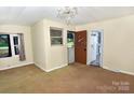 Inviting living area features neutral tones, a window with natural light and an open doorway at 709 Sunset Dr, Salisbury, NC 28147