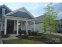 Attractive single-Gathering home with a manicured lawn, covered front porch, and a two-car attached garage at 813 Latrobe Dr # 365, Iron Station, NC 28080