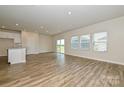 Open-concept living area with a kitchen island, hardwood floors and plenty of natural light at 815 Blue Canyon Dr, York, SC 29745