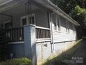 View of home showing exterior vinyl siding, brick foundation, and covered porch on side at 816 Parkwood Ave, Charlotte, NC 28205