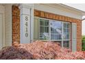 Close-up of the house number and brick facade, enhanced by beautiful landscaping at 8410 Darcy Hopkins Dr, Charlotte, NC 28277