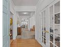 Inviting foyer with hardwood floors, complemented by an entry to another room behind double doors at 8410 Darcy Hopkins Dr, Charlotte, NC 28277