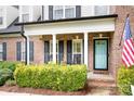Covered front porch with blue door and decorative shrubs for enhanced curb appeal at 9000 Petunia Ct, Gastonia, NC 28056