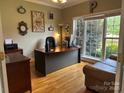 Inviting home office with hardwood floors, large window, and comfortable seating at 9000 Petunia Ct, Gastonia, NC 28056