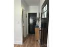 Inviting hallway featuring wood-look floors and modern black doors at 918 8Th St # 5, Lancaster, SC 29720