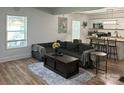 Open-concept living room with a large couch, kitchen bar and lots of natural light at 918 8Th St # 5, Lancaster, SC 29720