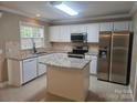 Bright kitchen with white cabinetry, stainless steel appliances, island, and granite countertops at 9237 Bellegarde Dr, Charlotte, NC 28277