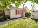 This exterior view shows the side yard, red shutters, brick detail, and well-maintained landscaping at 9360 Meadowmont View Dr, Charlotte, NC 28269