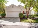 Home featuring a well-kept front yard with a two-car garage and complementary red shutters on the windows at 9360 Meadowmont View Dr, Charlotte, NC 28269