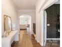 Inviting hallway with hardwood floors and stylish decor leads into the living area at 1001 Linn Cv, Waxhaw, NC 28173