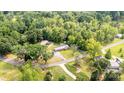 Aerial shot revealing a quaint property nestled amongst mature trees, featuring an expansive yard at 1094 Curve View Rd, Lincolnton, NC 28092