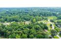 Expansive aerial shot showing a lush, densely wooded landscape surrounding a rural property at 1094 Curve View Rd, Lincolnton, NC 28092