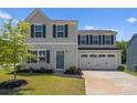 Two-story home with light gray siding, dark blue shutters, well-manicured lawn and two car garage at 110 Browband St, Troutman, NC 28166