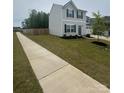 Charming two-story home featuring a well-manicured lawn and a side walk at 110 Browband St, Troutman, NC 28166