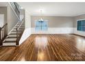Spacious living room featuring hardwood floors, wainscoting, and large windows at 110 Colville Rd, Mooresville, NC 28117