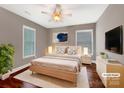 Comfortable main bedroom featuring a ceiling fan, windows, and hardwood floors at 110 Colville Rd, Mooresville, NC 28117
