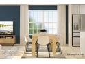 Bright dining room features a wooden table, six chairs, and a large window with natural light at 1102 Old Trade St, Edgemoor, SC 29712