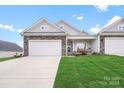 Charming home featuring a stone and siding exterior with a well-manicured front yard and a two-car garage at 122 A Deer Brook Dr # A, Shelby, NC 28150