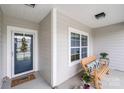 Inviting front porch with a cozy bench, wreath on door, and decorative plants, offering a warm welcome at 122 A Deer Brook Dr # A, Shelby, NC 28150