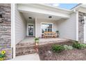 Inviting front porch with brick steps, a cozy bench, and decorative plants, offering a warm welcome at 122 A Deer Brook Dr # A, Shelby, NC 28150