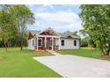 Inviting single-story home with a long driveway and covered front porch, nestled on a lush green lawn at 1244 Bob Falls Rd, Shelby, NC 28150